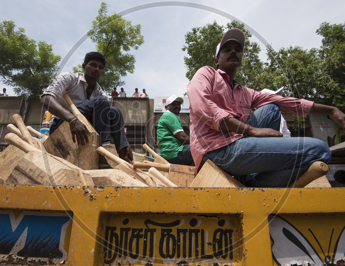 workers sitting on the wooden blocks in a truck