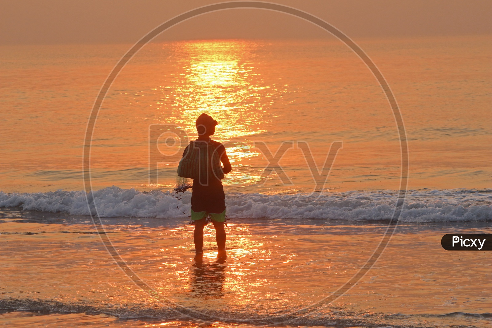 Fisherman at RK Beach during sunrise