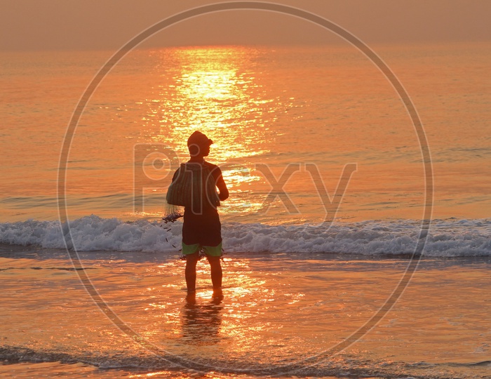 Fisherman at RK Beach during sunrise