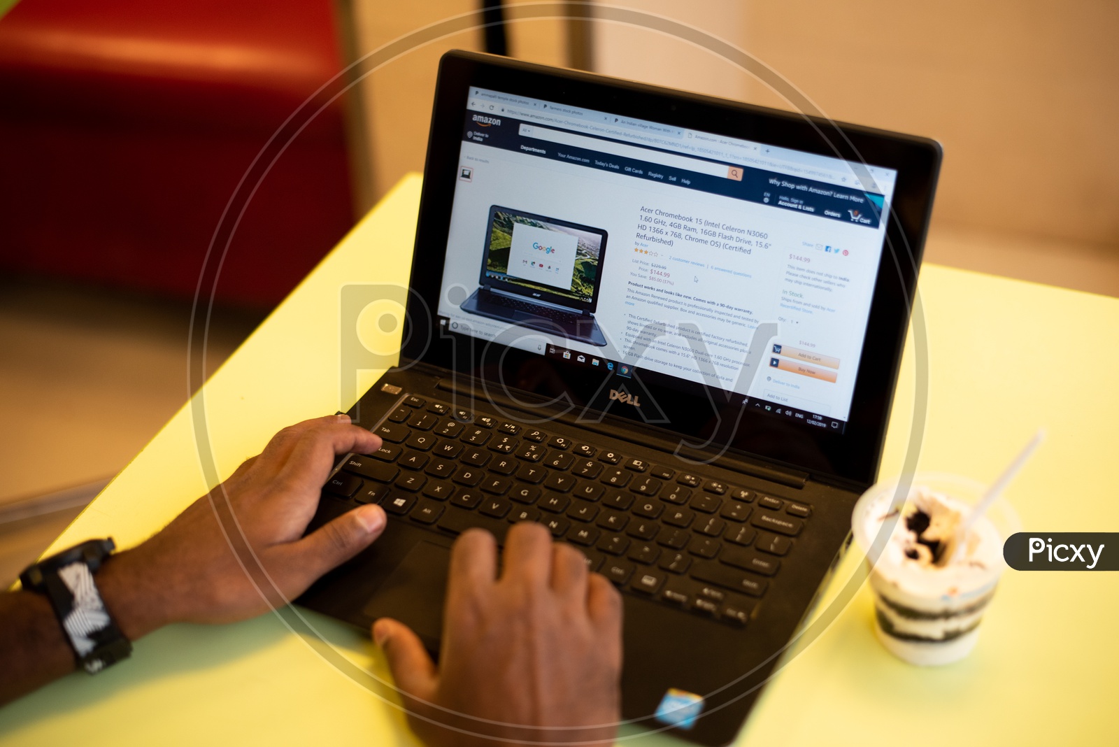 A man using Amazon, e-commerce website for shopping on a Laptop PC
