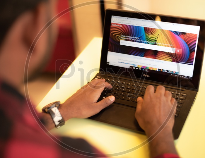 A man searching photos in Shutterstock, an online Stock photo company