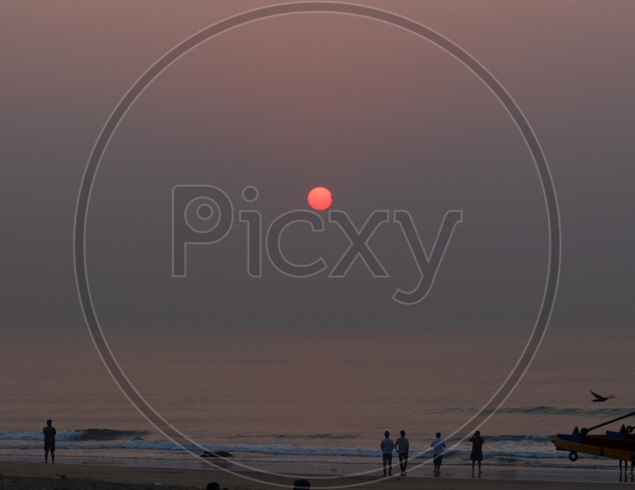 Sunrise from clouds at foggy RK beach