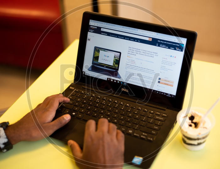 A man using Amazon, e-commerce website for shopping on a Laptop PC