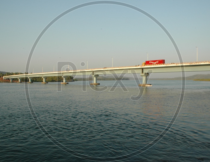 A red truck on the Mandovi bridge over the Mandovi river