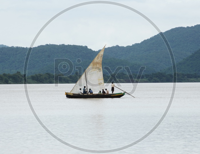 People moving on a sail boat on the river