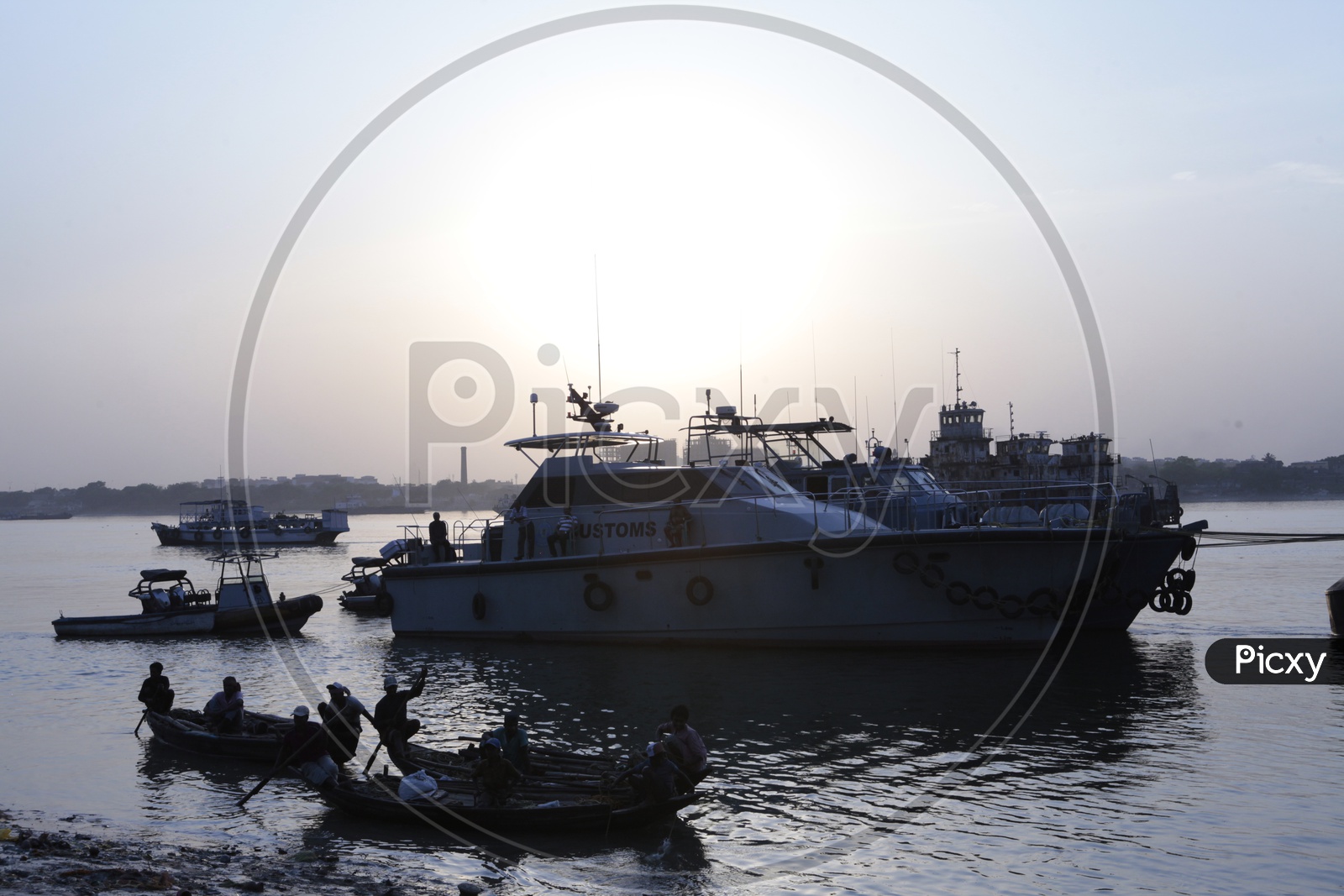 Gandolas and Customs Boats alongside the Hooghly River during the sunset