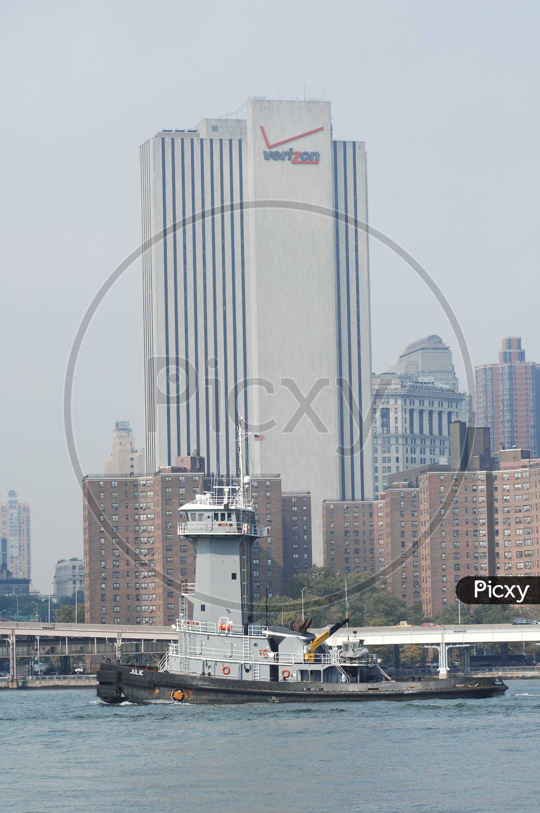 Tug boat on the sea with Verizon skyscraper in background