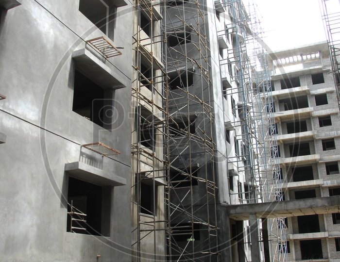 Buildings under construction and iron rods fixed to the walls