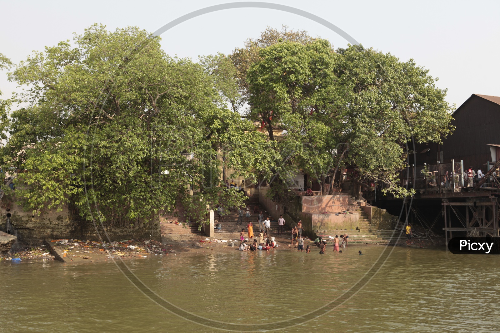 Local people taking a bath alongside the Ghats of Hooghly River