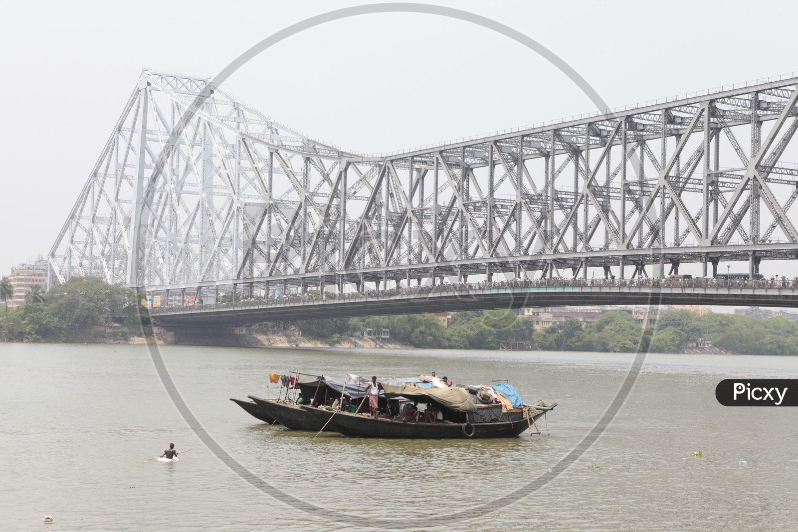 Boats sailing in Kolkata with Howrah Bridge in the background