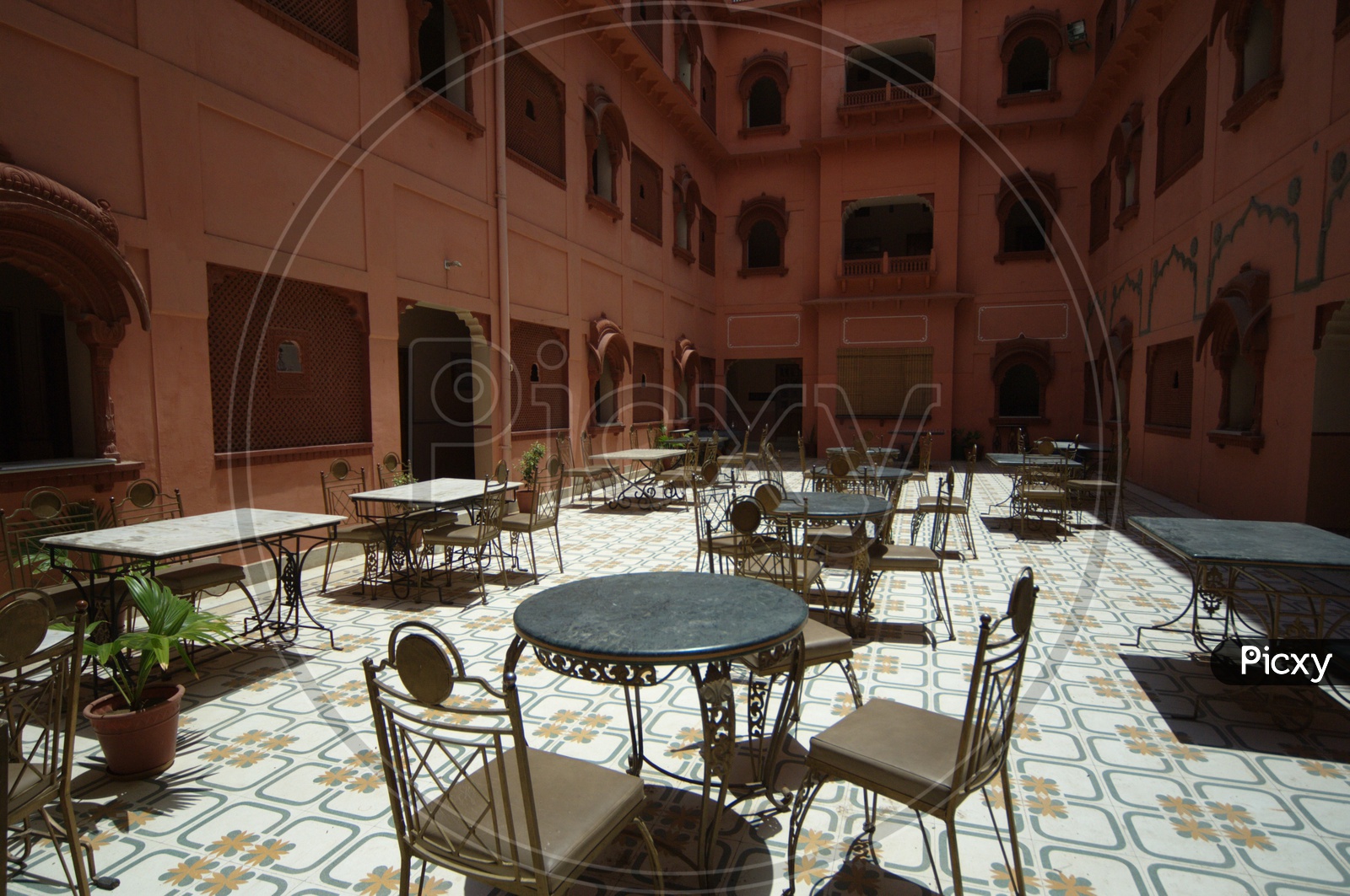 Antique tables and chairs in open area at Junagarh fort