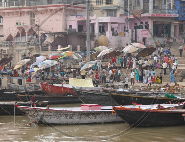 Boats and tourists in the river along the varanasi Ghats