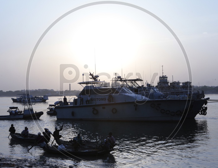 Gandolas and Customs Boats alongside the Hooghly River during the sunset