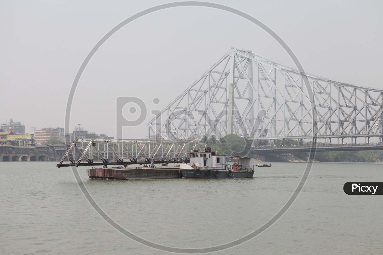 Landing Craft Mechanized on the Hooghly River alongside the Howrah Bridge