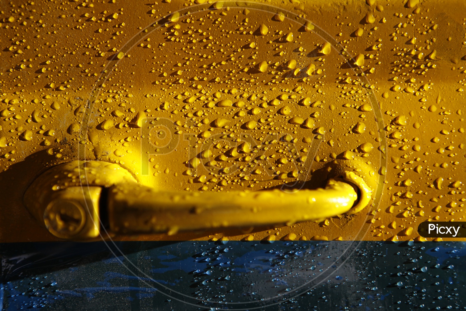 Water Droplets On a Car Door Closeup Shot