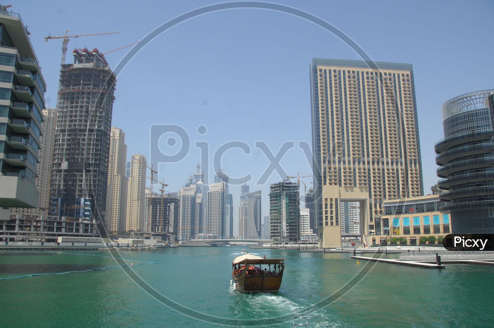 View of the city from of the beach - Blue waters, boat, tall buildings seen