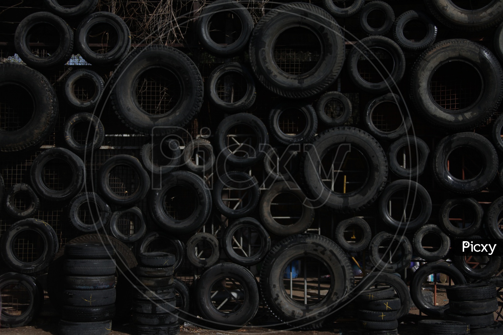 Tyres Arranged on a Wall In  a Manner  Forming  a Background