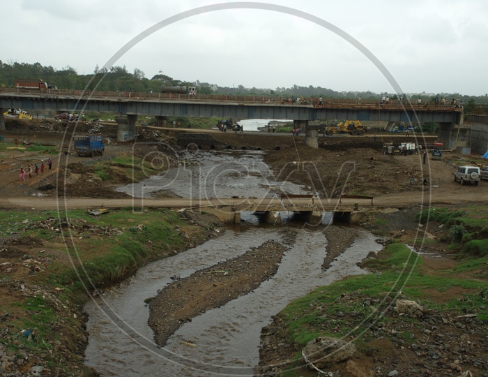 Construction of bridge alongside the stream channel of water