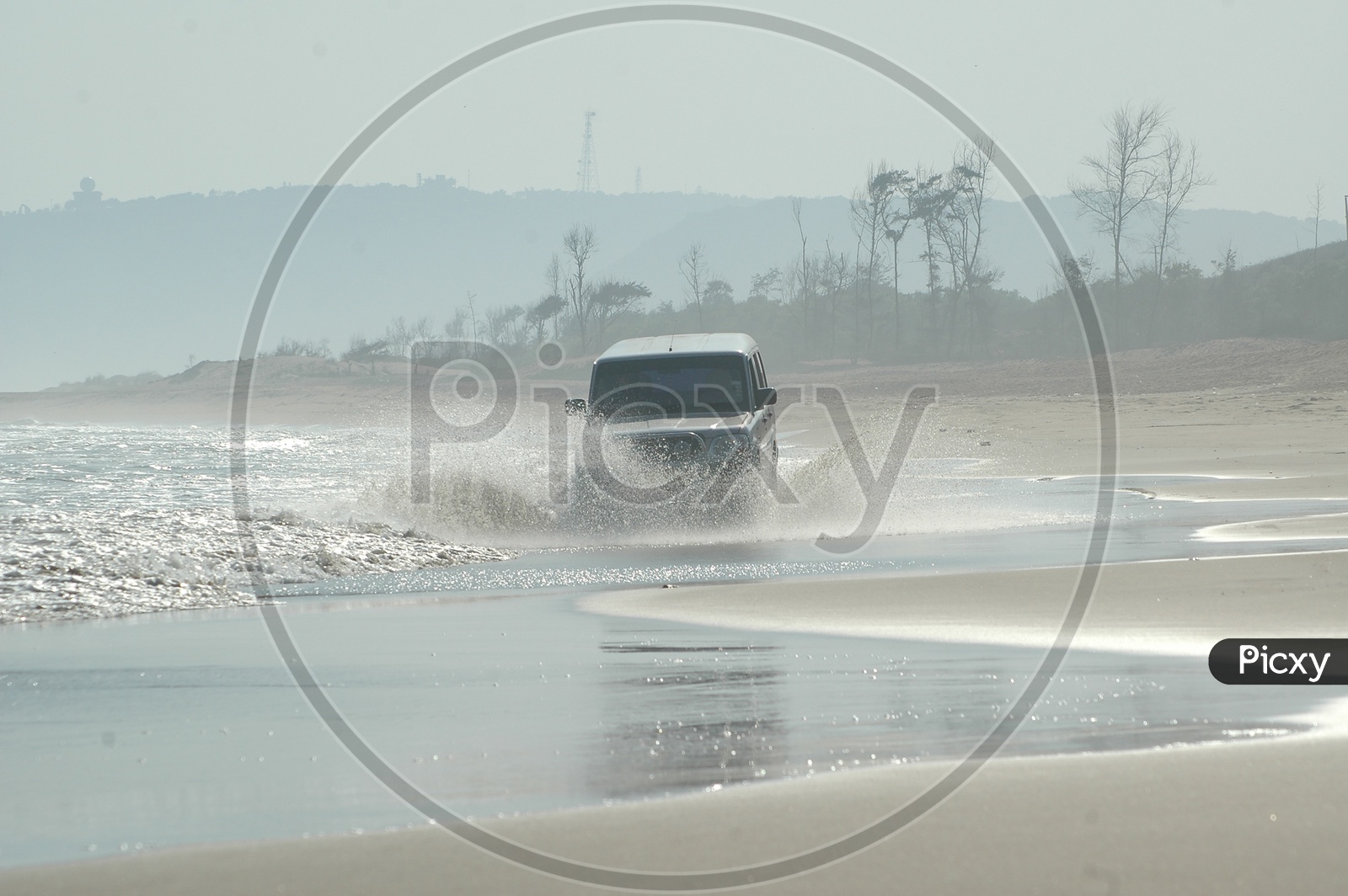 A Car Riding through The Beach Waves