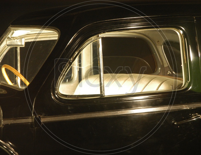 A Closeup Shot of a Vintage Car Through Window