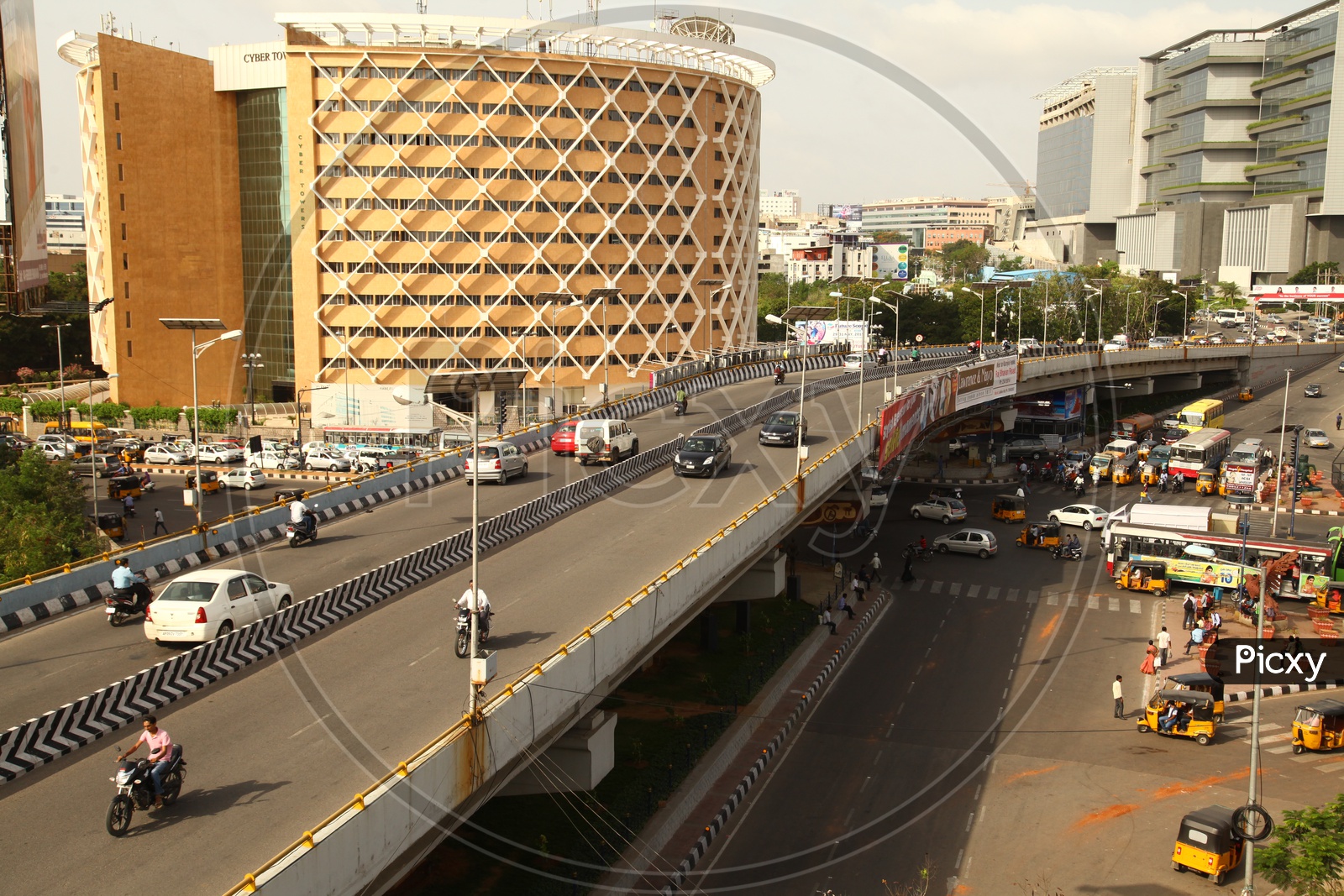 View of the Cyber Towers building in Hyderabad with vehicles moving in the foreground