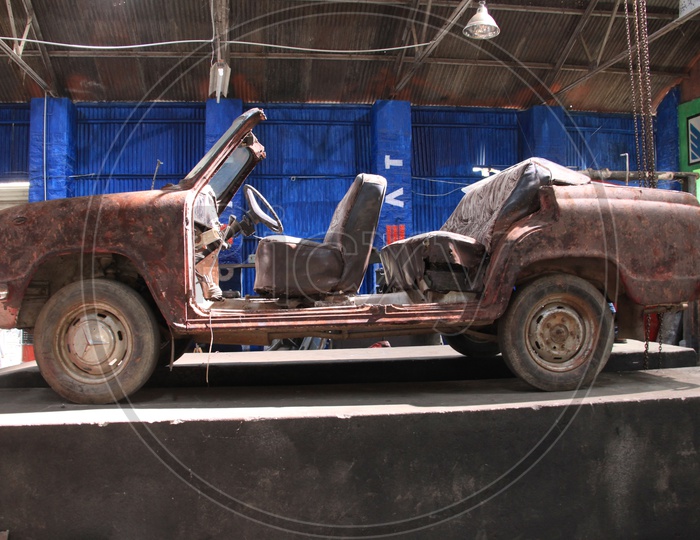 Old Rusted And Wrecked Car in a Fusty Shed