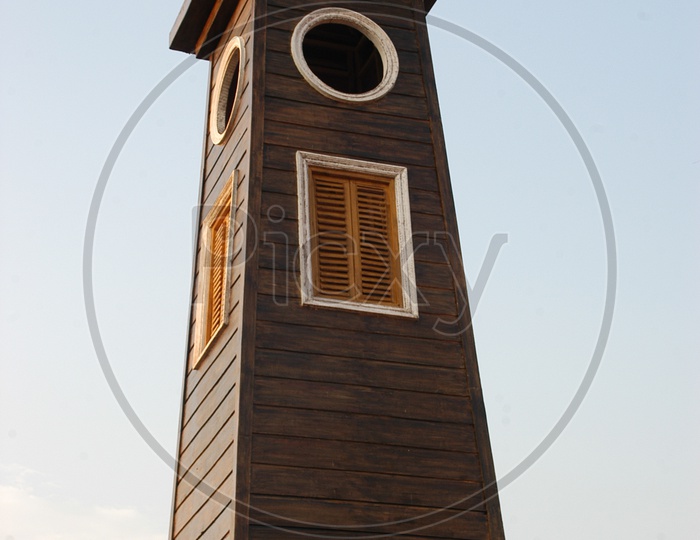 Wooden clock tower with clear sky in background