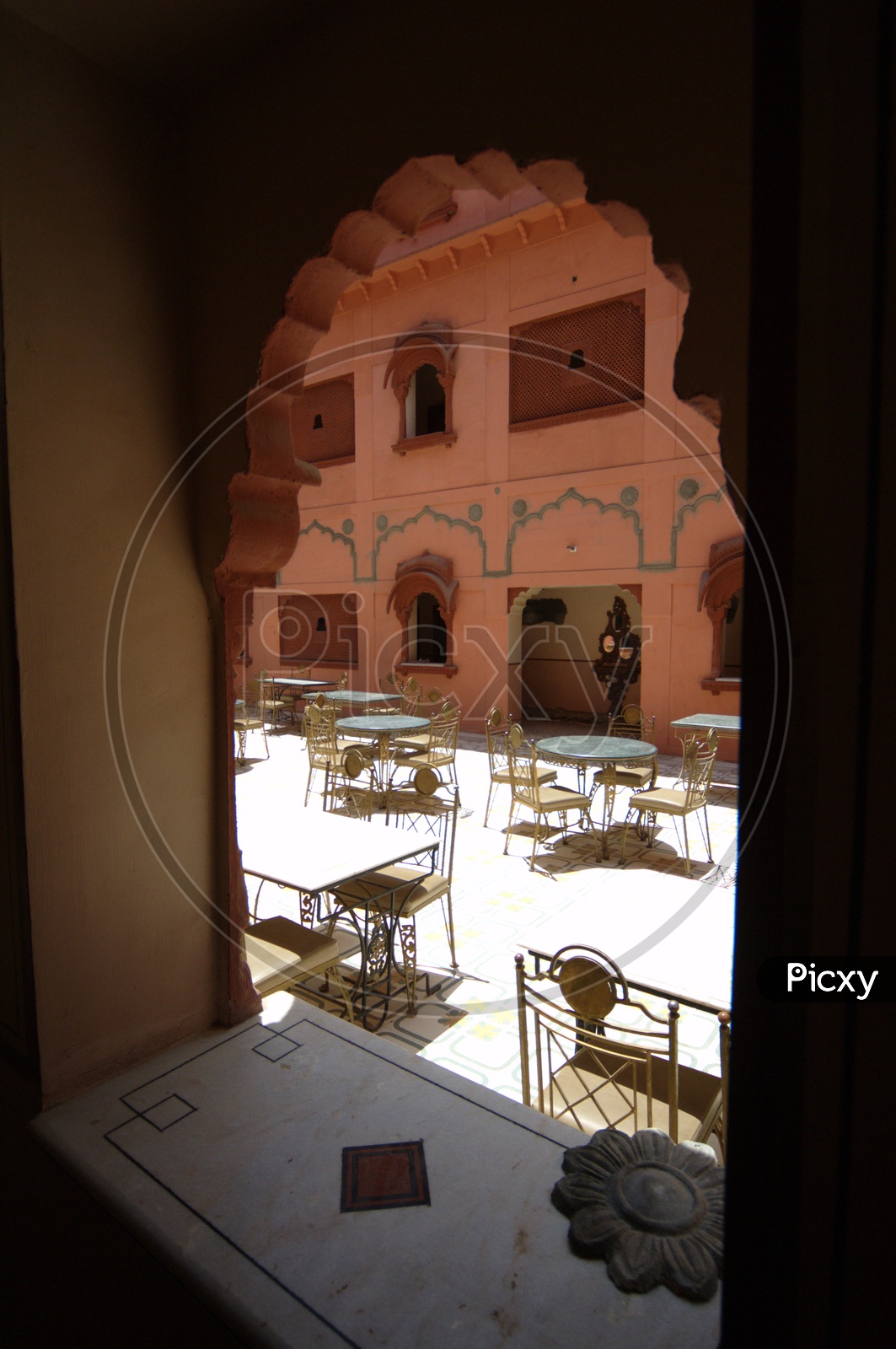 Antique tables and chairs in open area at Junagarh fort