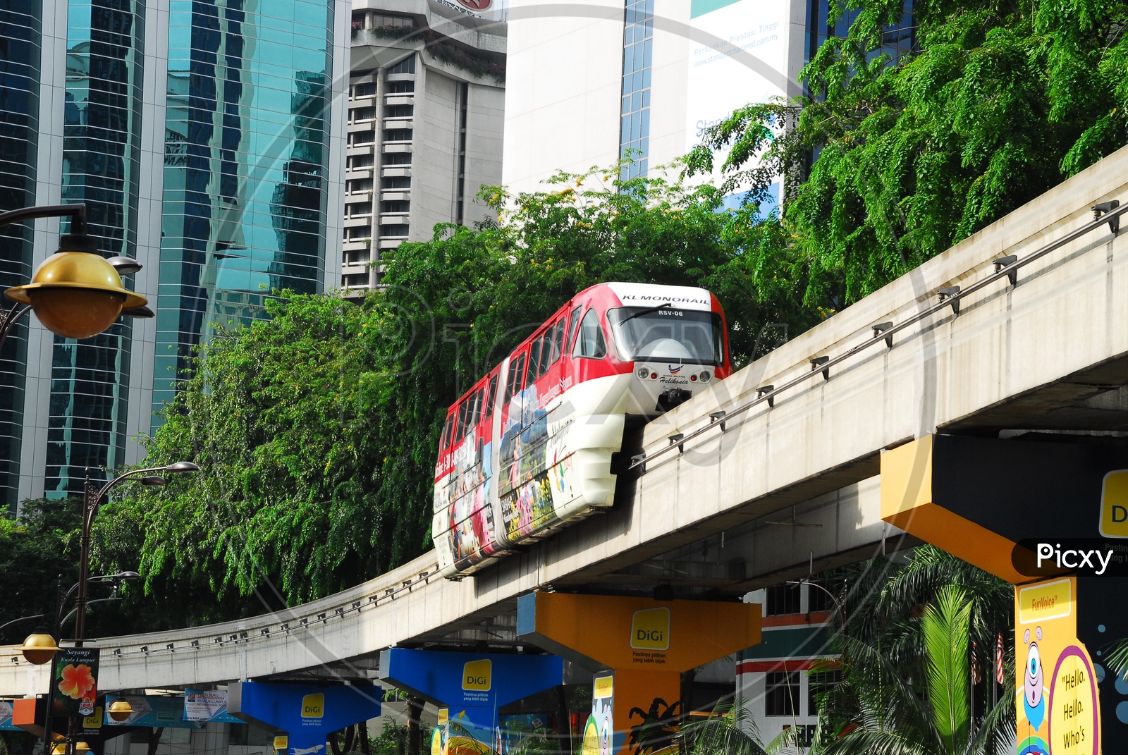 Monorail moving along the bridge way with city buildings in background