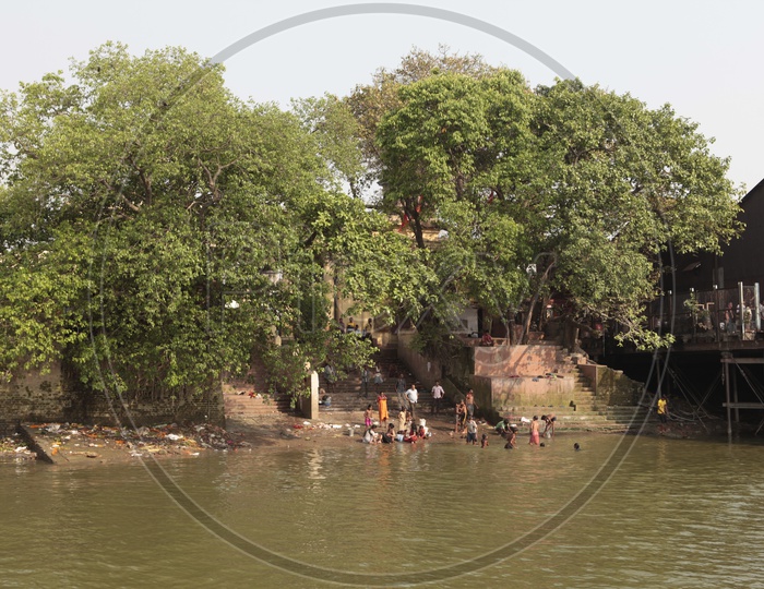 Local people taking a bath alongside the Ghats of Hooghly River
