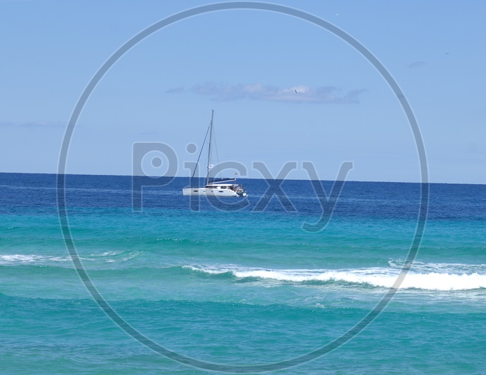 View of the boat in the middle of the beach - Blue waters
