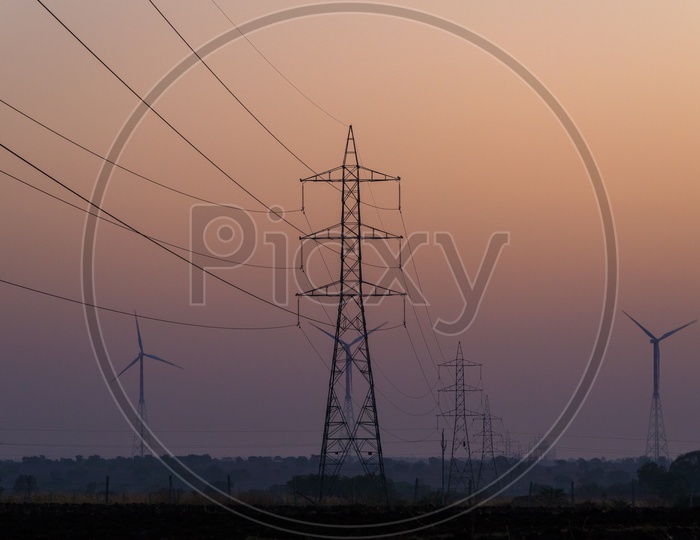 Windmills and Electric lines during Sunset