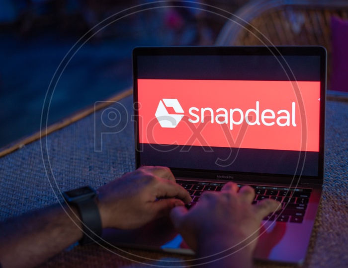 Indian Man Accessing Snapdeal Portal In Laptop