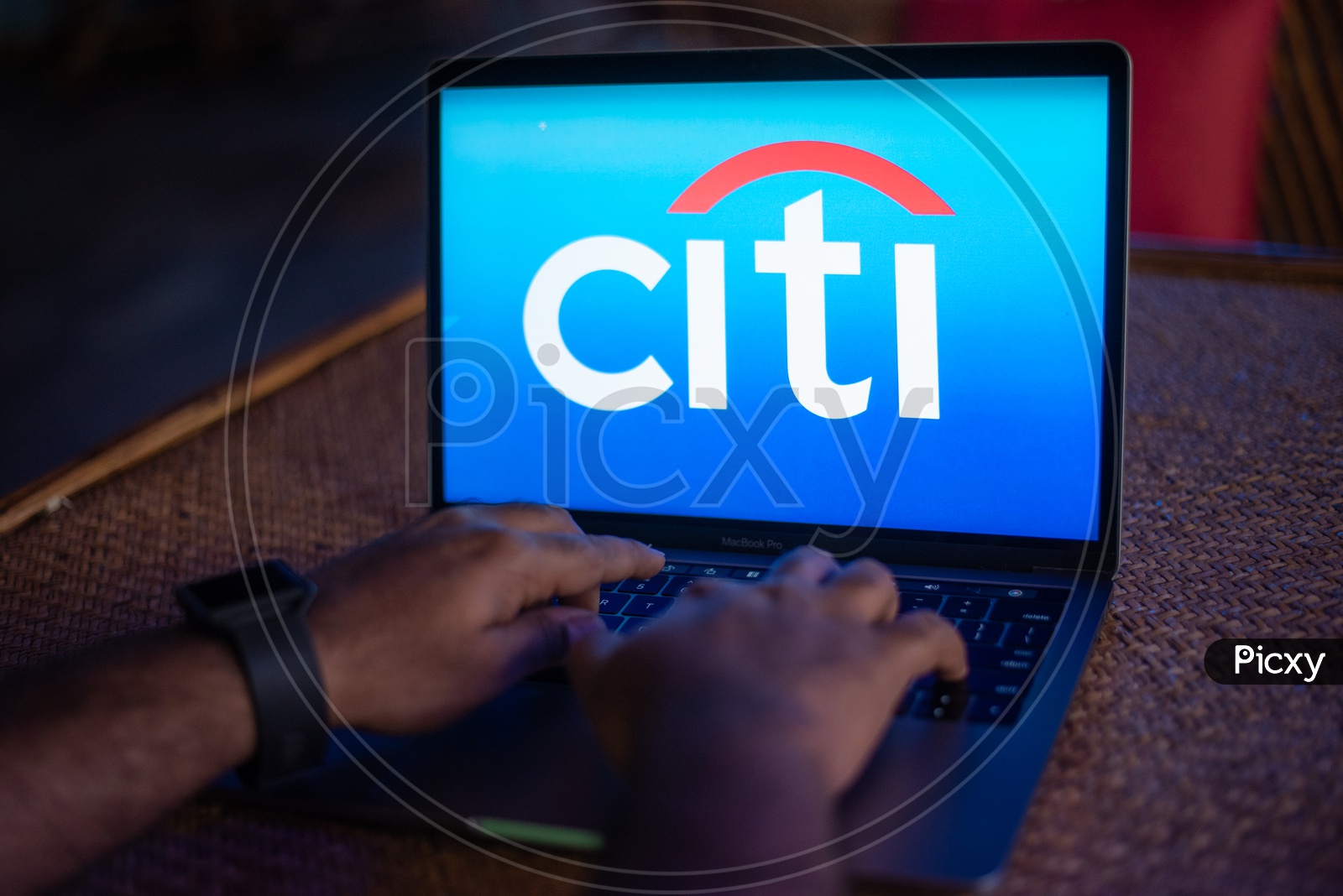 Indian Youth Accessing Online Banking Of  Citi  BANK  in Laptop