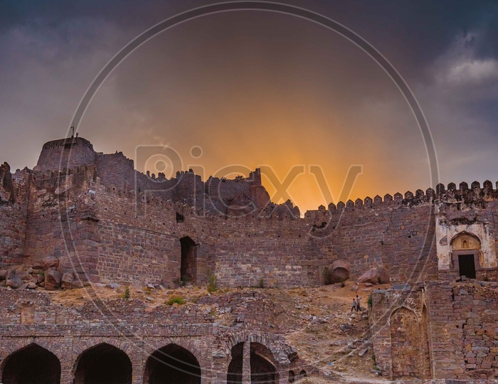 Architecture Of Golconda Fort With A Golden Hour Sky In Background