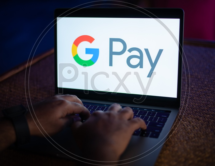 Indian Youth Accessing Google Pay ( G Pay )   in Laptop