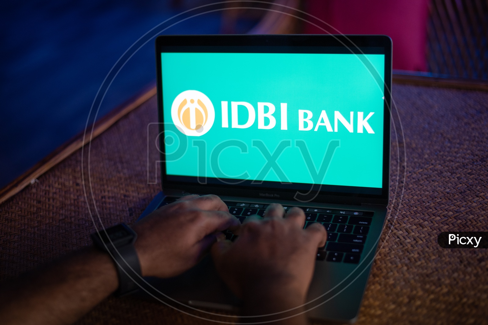 Indian Youth Accessing Online Banking Of IDBI BANK  in Laptop
