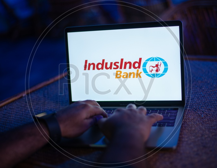 Indian Man Accessing The IndusInd Bank Online Portal In Laptop
