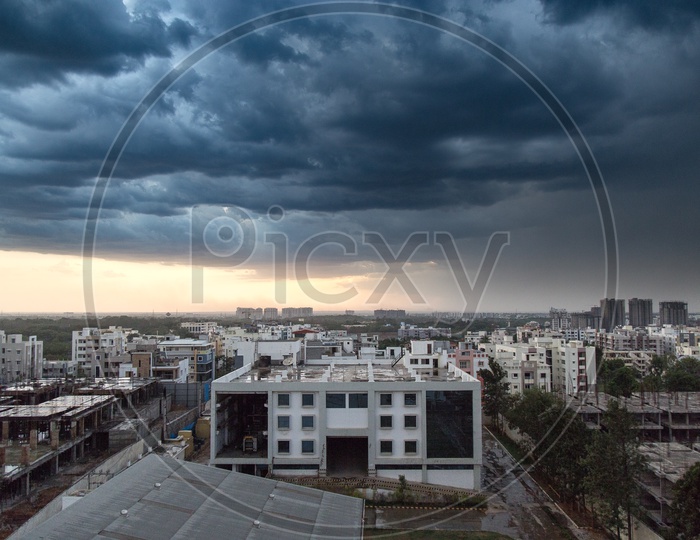 Hyderabad City Scape With High Rise Buildings With Thick Dark Clouds In Sky