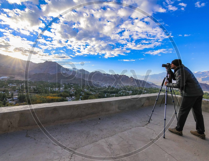 Man shooting the Landscape of the hills during sunrise