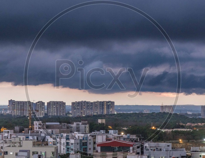 Hyderabad City Scape With High Rise Construction Buildings And Apartments over  Dark  Clouds Background