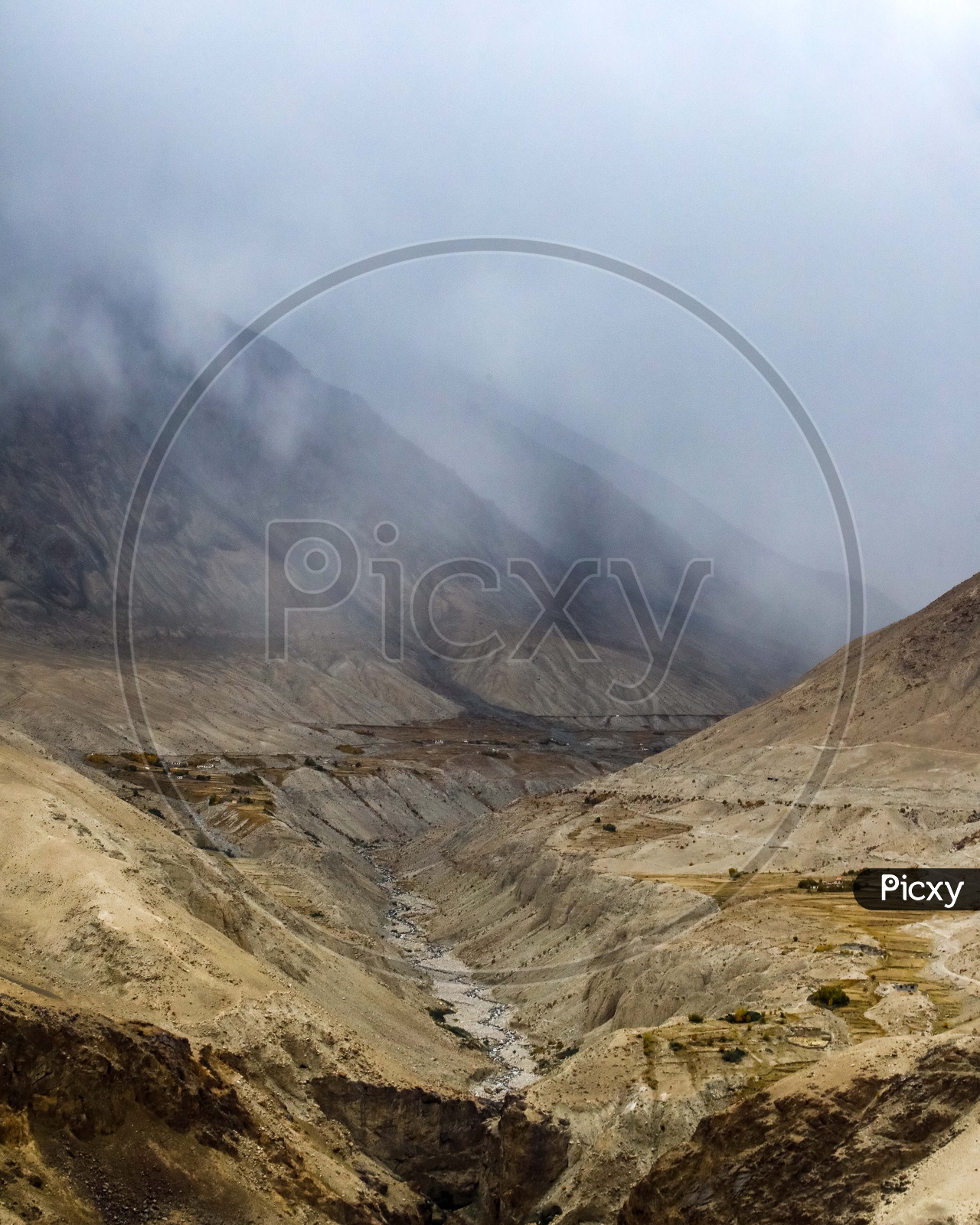 Indus River in front of the Zanskar Range with misty mountains