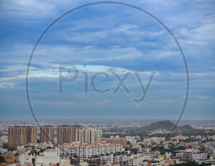 Hyderabad City Scape With High Rise Buildings And Apartments over  a Bluse Sky with Cotton Clouds