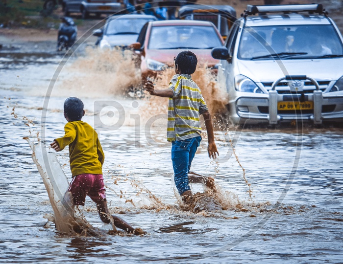 Children Crossing The Flooded Roads