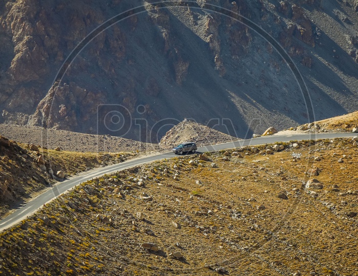 Moving car on the roadway amidst of hills