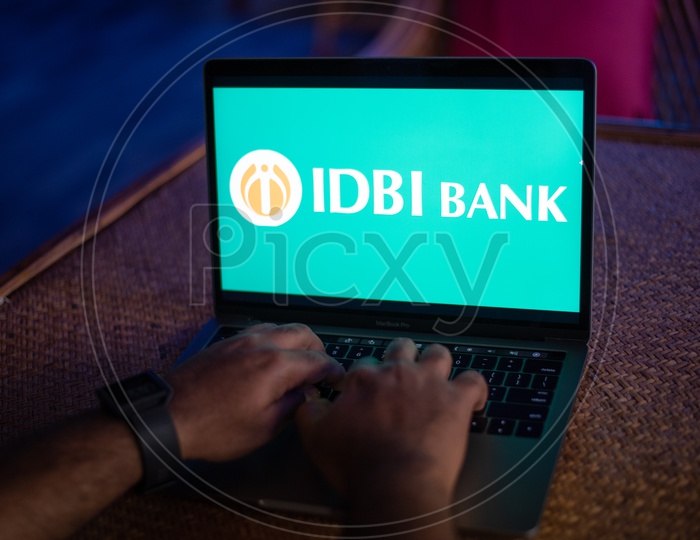 Indian Youth Accessing Online Banking Of IDBI BANK  in Laptop