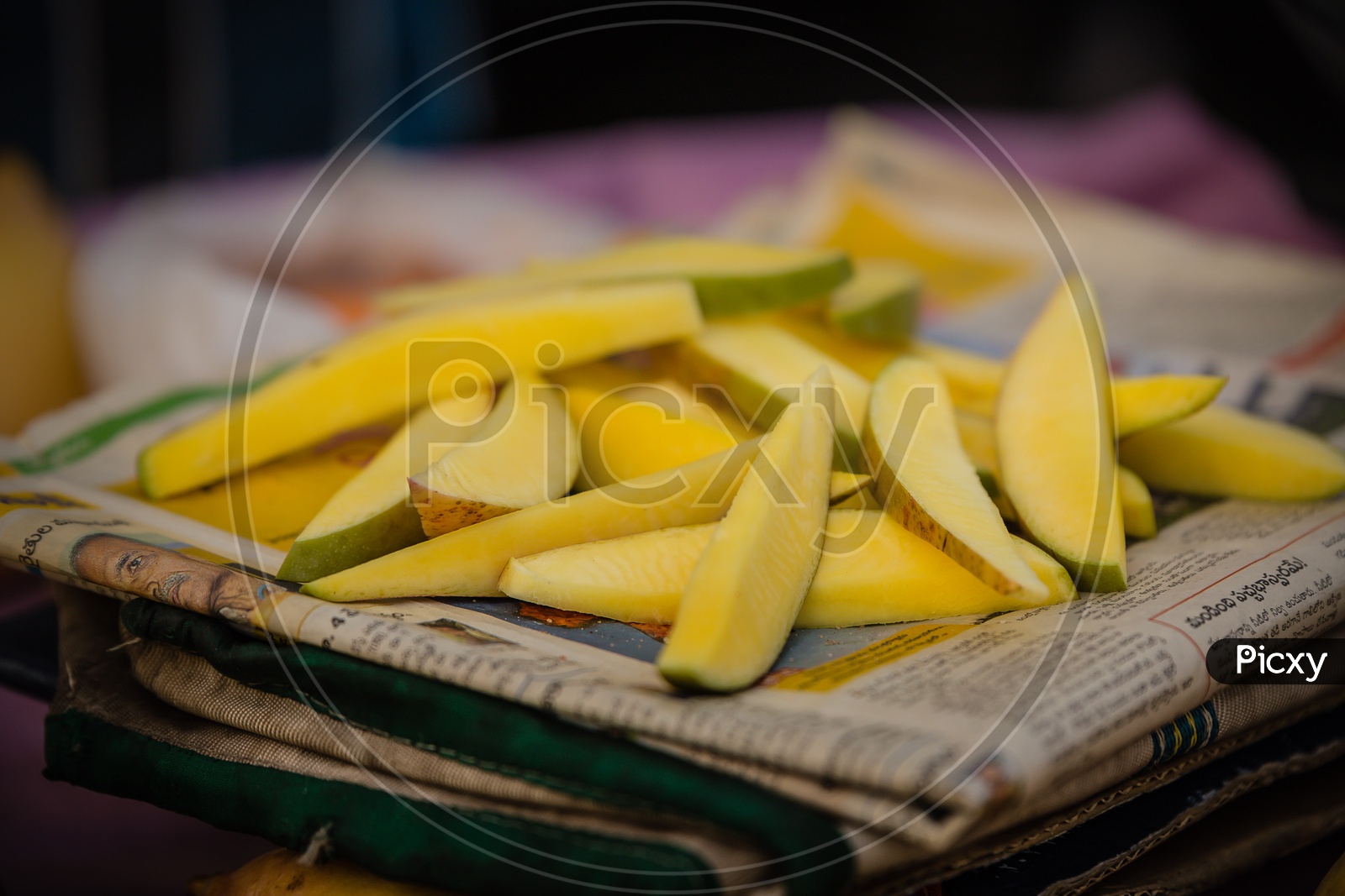 Mango Slices on the newspaper at a street bazaar