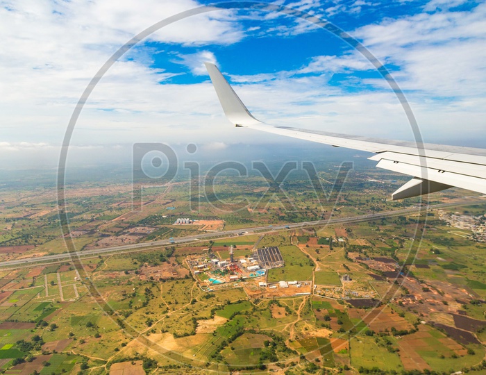 Aerial View of agricultural Fields and Flight Wing From Flight Window