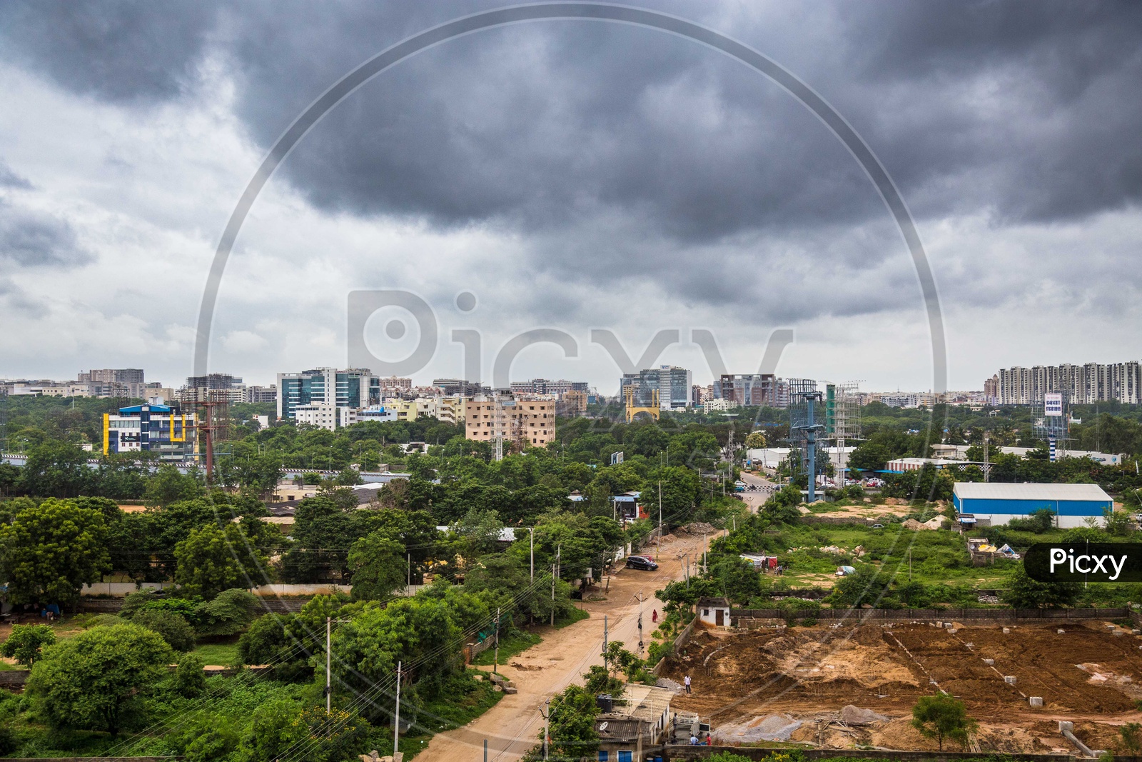 City Scape View With Apartments And Dark Black Clouds In Sky
