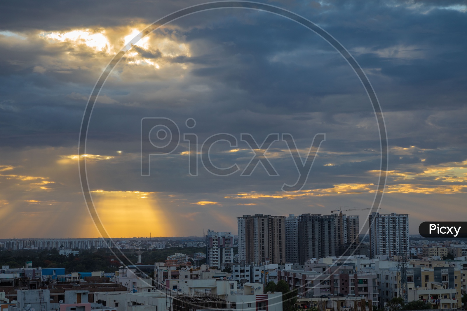 Hyderabad City scape With High Rise Buildings Over a Golden Hour Sky With Dark Clouds